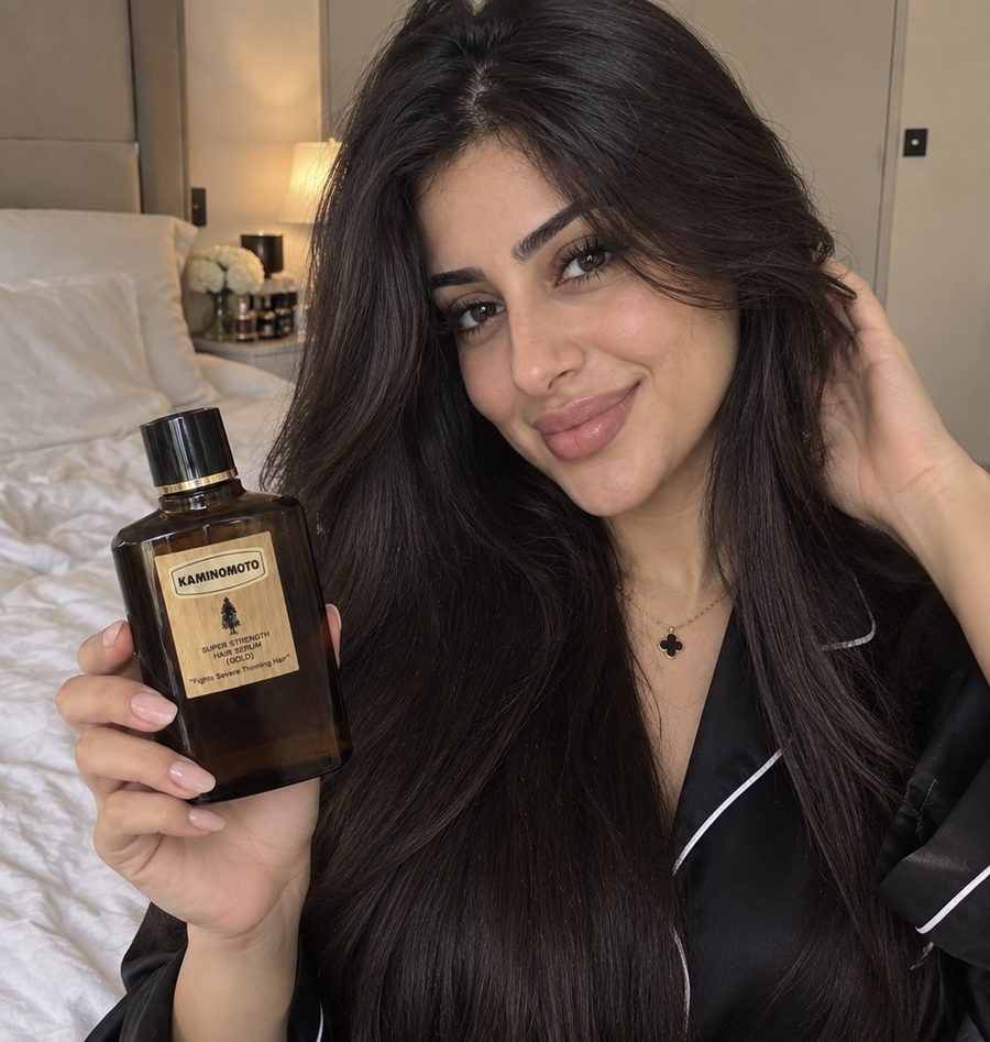 Woman with thick hair holding Kaminomoto serum